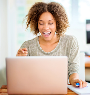 African American Girl Smiling by Computer