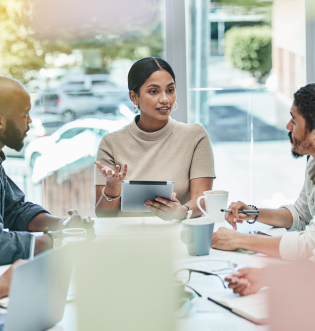 Indian Woman holding tablet talking to 2 men in office