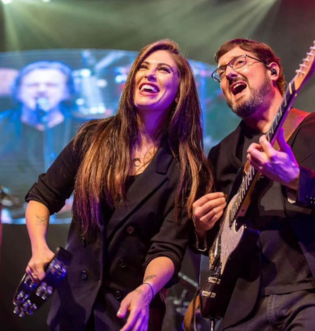 Jessica smiling with guy playing guitar