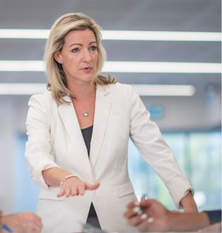 Woman in white suit leading a meeting