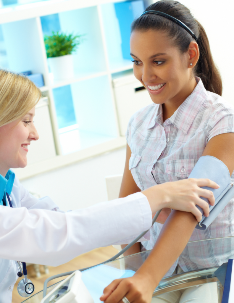 dr taking woman's blood pressure