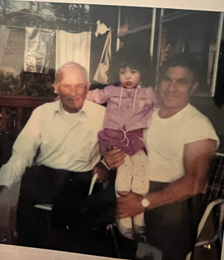 Dad and Grandfather holding granddaughter
