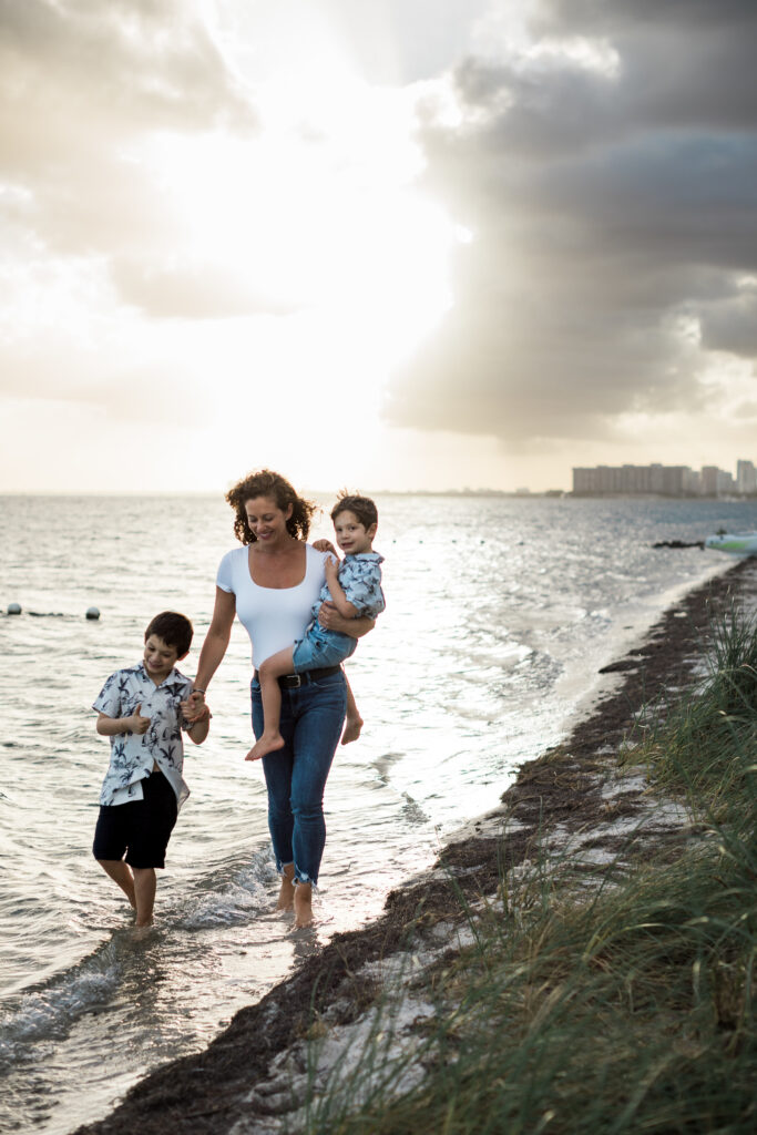 Woman and kids walking on beach