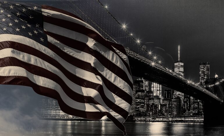 American flag flying the a Skyline view new york city manhattan downtown skyline at night