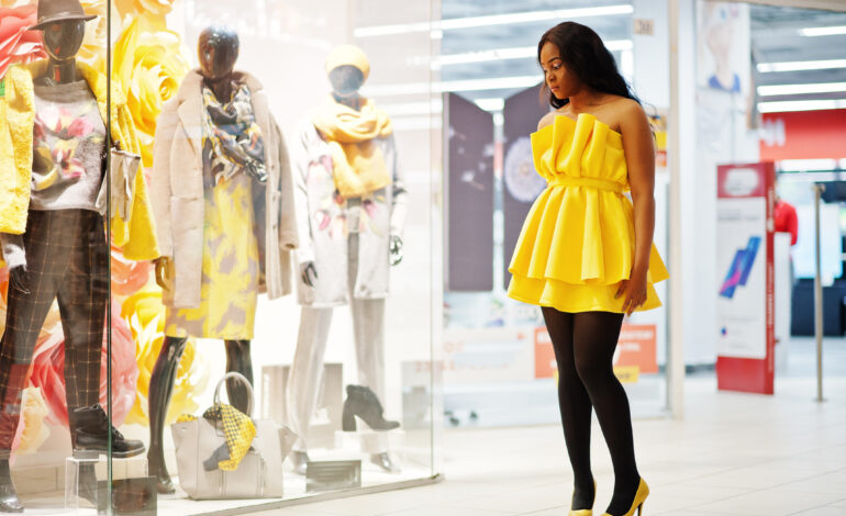 Stylish african american woman at yellow dress