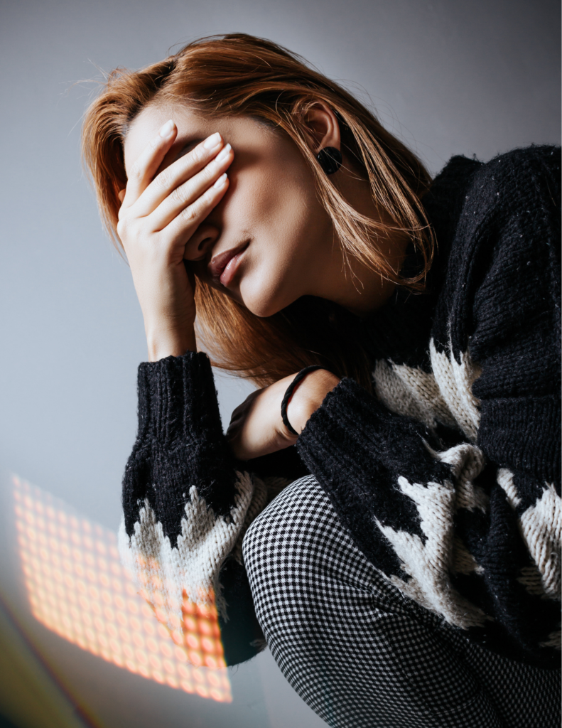 Woman stressed out with hands over face