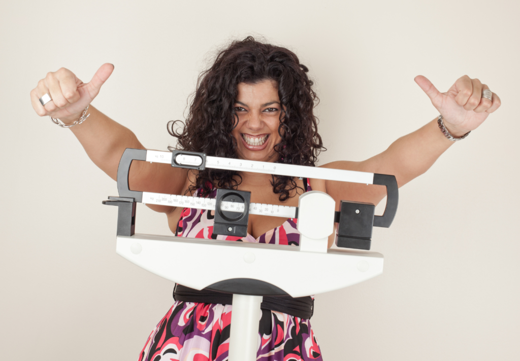 Woman excited by results of weight scale