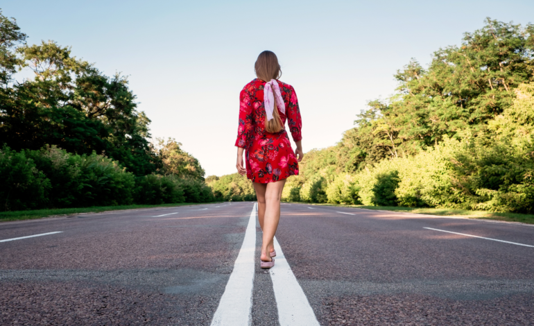 Woman walking down road