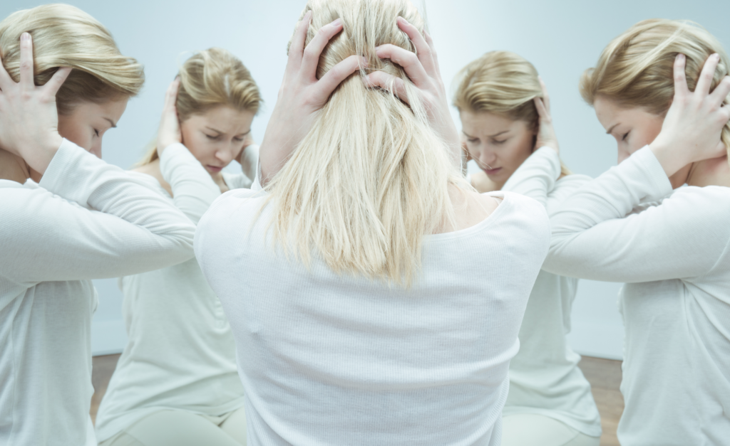 woman in white with hands over ears