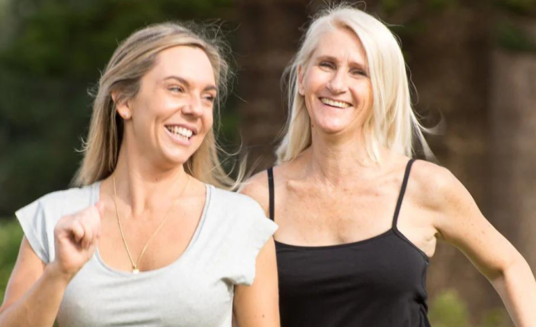 2 women laughing while on a walk