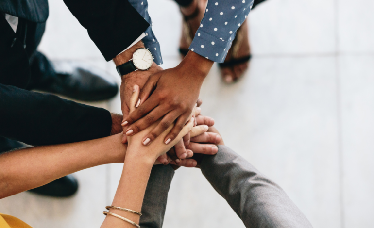 diverse hands of business people in hand huddle