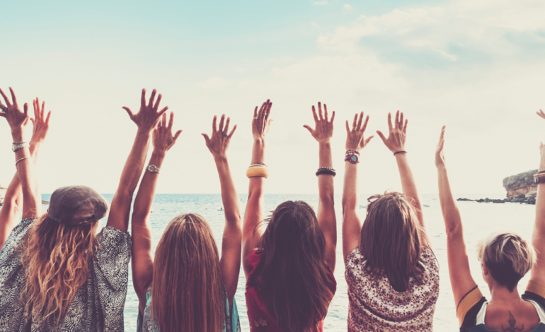 Group of Women Viewed from Back with Arms up for Happiness in Friends