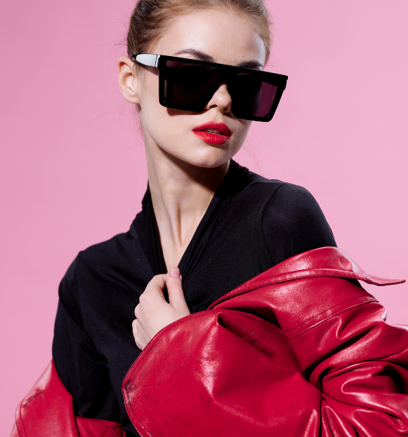 Lady in sunglasses with black shirt and red jacket