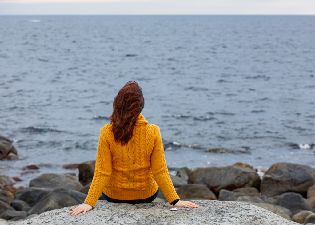 Woman being mindful staring at ocean