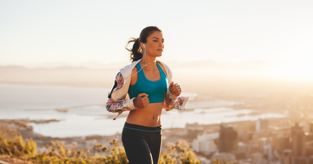 Woman jogging along beach