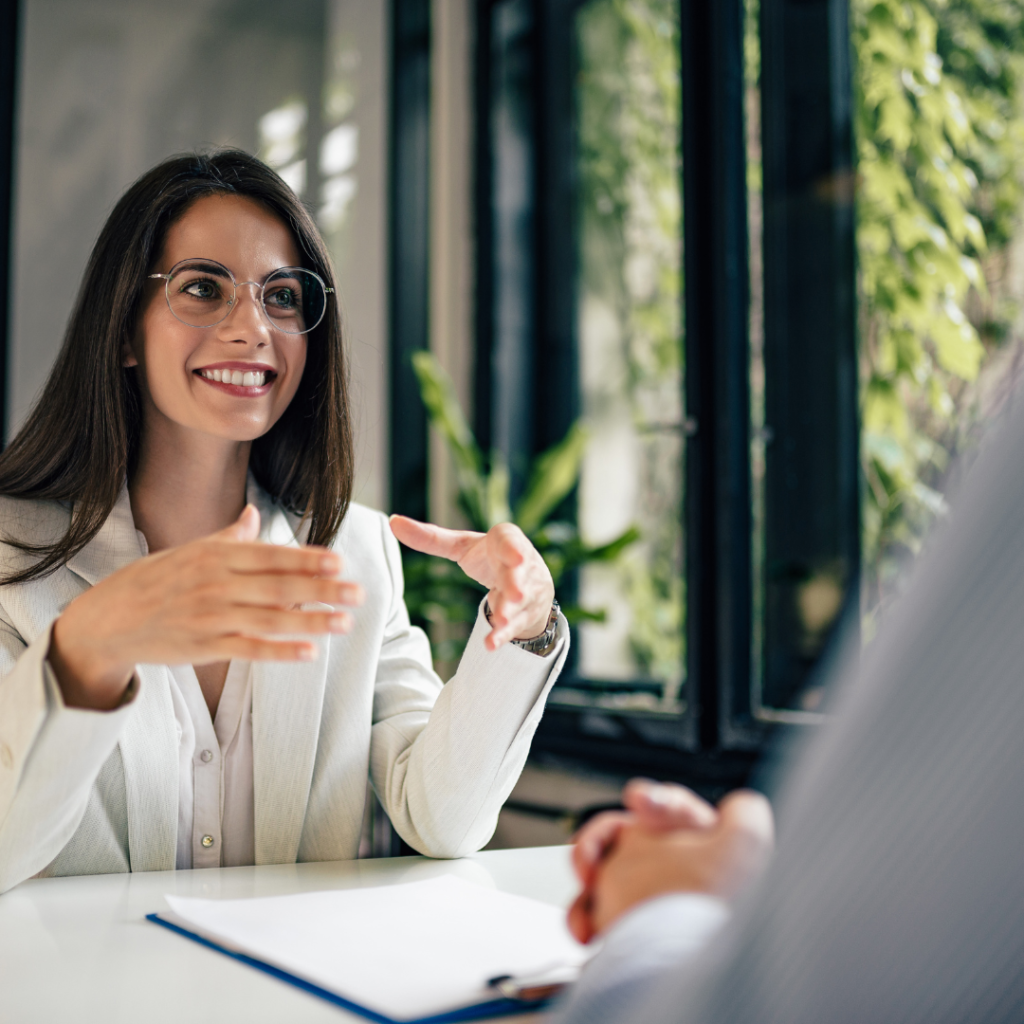 business woman talking to client over desk