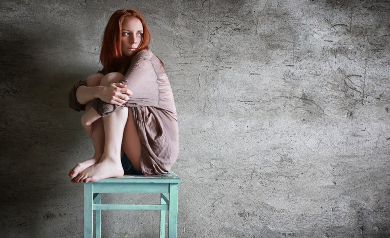 scared woman sitting on chair