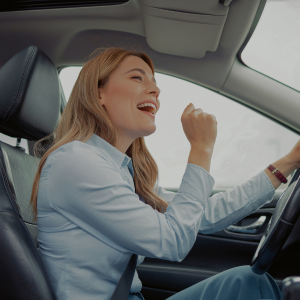 happy woman listening to music while driving