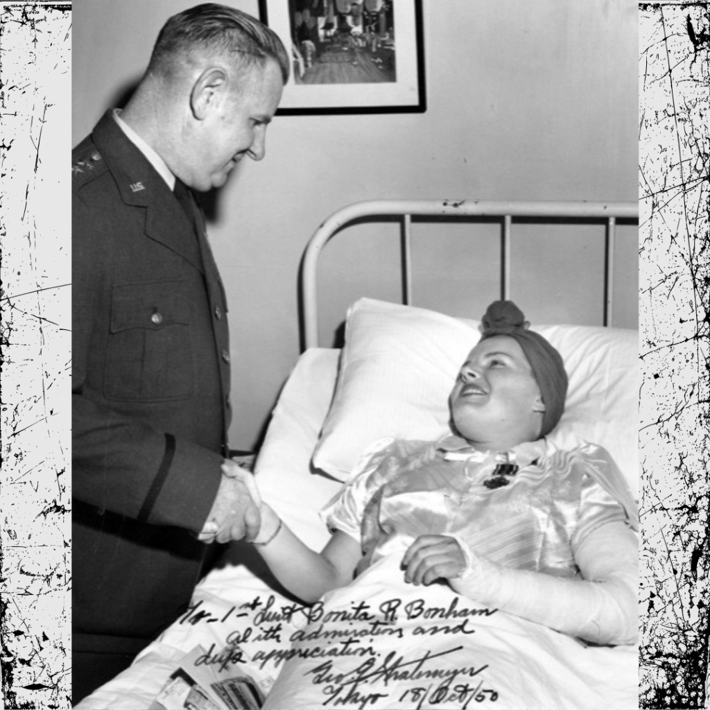 vintage photo of woman in hospital bed shaking military officers hand