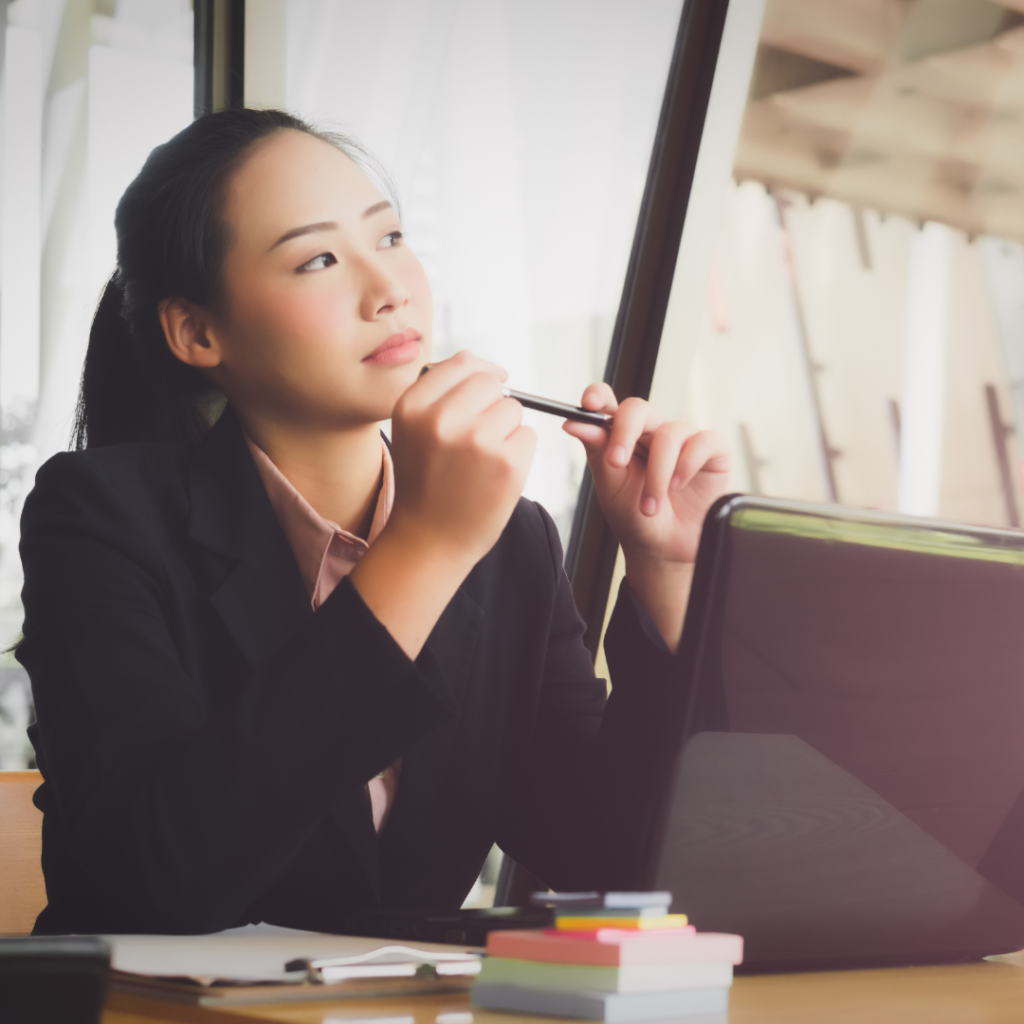 woman sitting at desk critically thinking