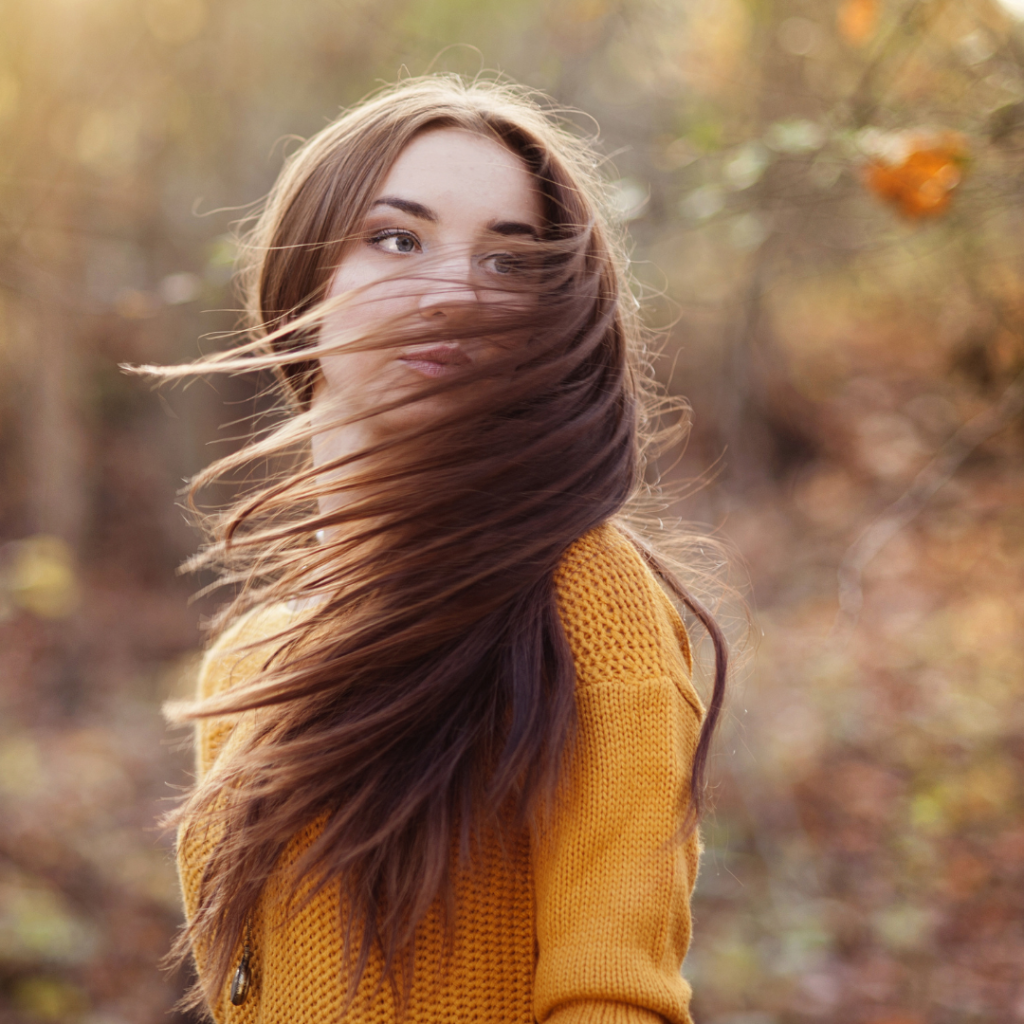 woman flipping hair in autumn