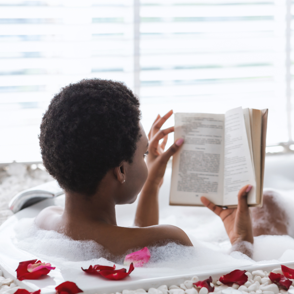 woman reading book in bathtub