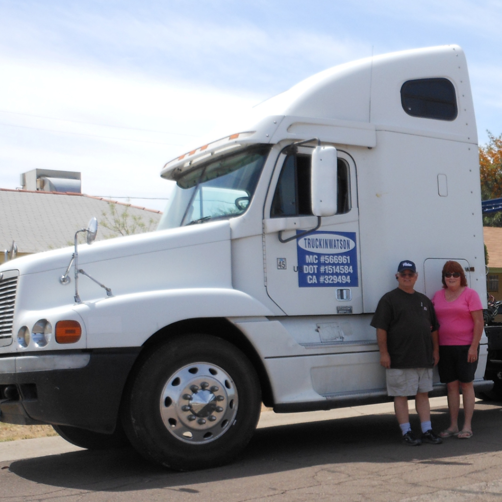 couple in front of big rig truck