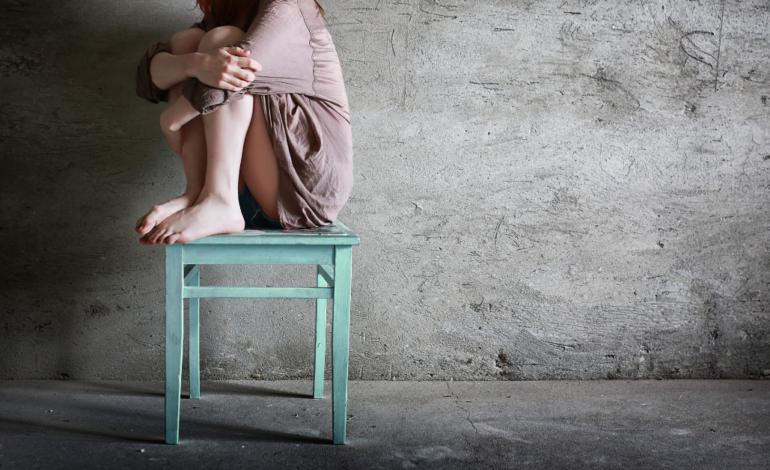 Scared Woman on a Chair