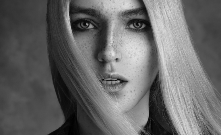 Black and White Image of Female with freckles and blonde hair