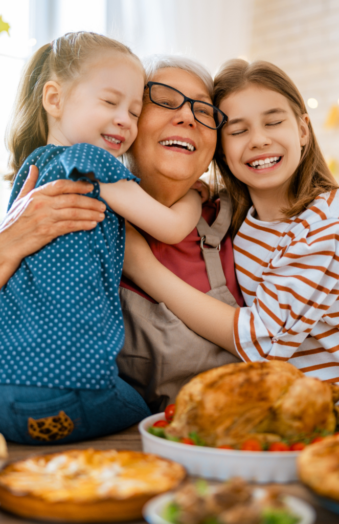 Grandkids hugging Grandma at Thanksgiving