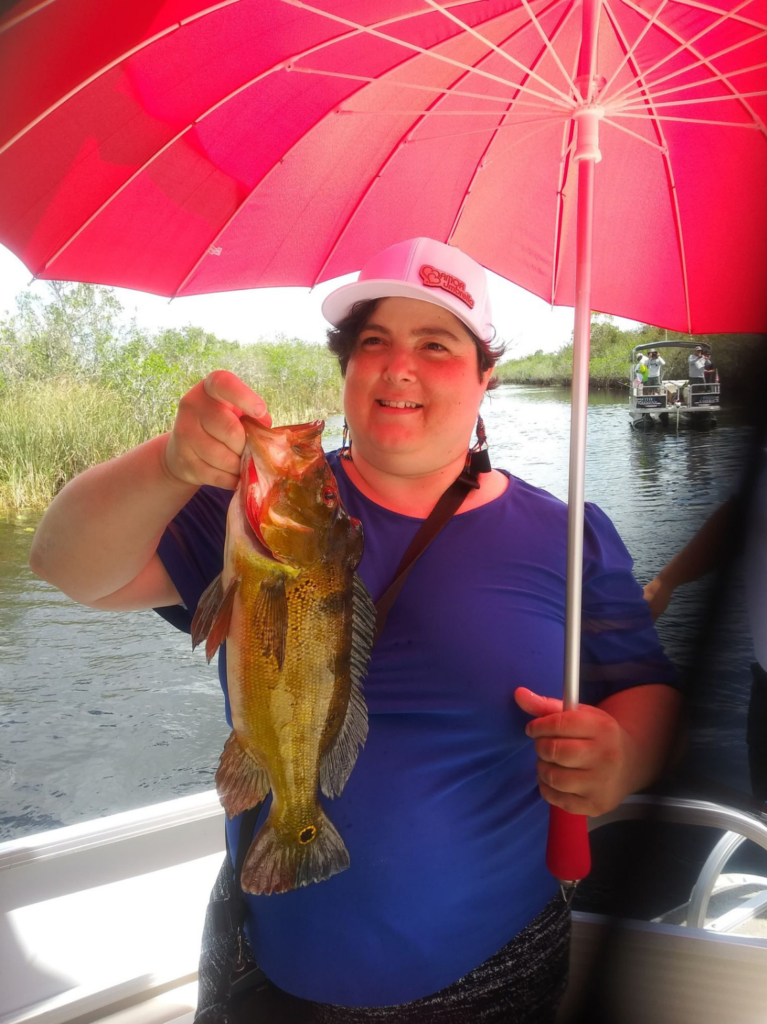 Niurka Castaneda Holding Fish and Amor Umbrella