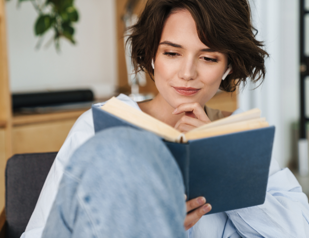 Woman reading book sitting on chair