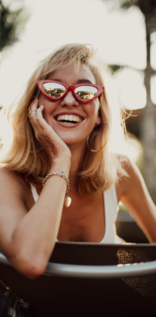 Woman smiling in sunglasses