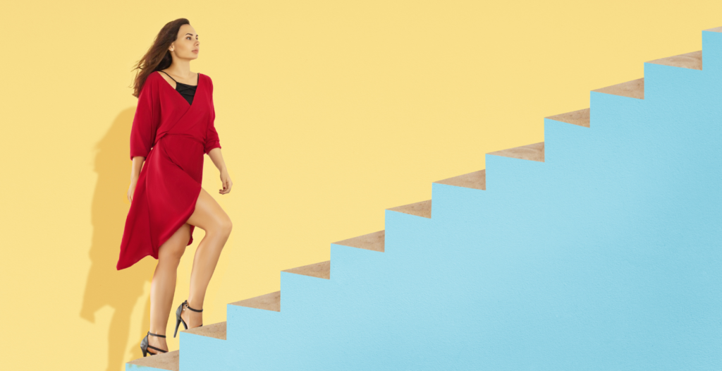 Female climbing stairs to success