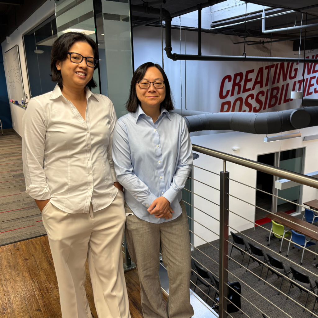 MyPhuong Le and Leah Villegas standing in office next to balcony