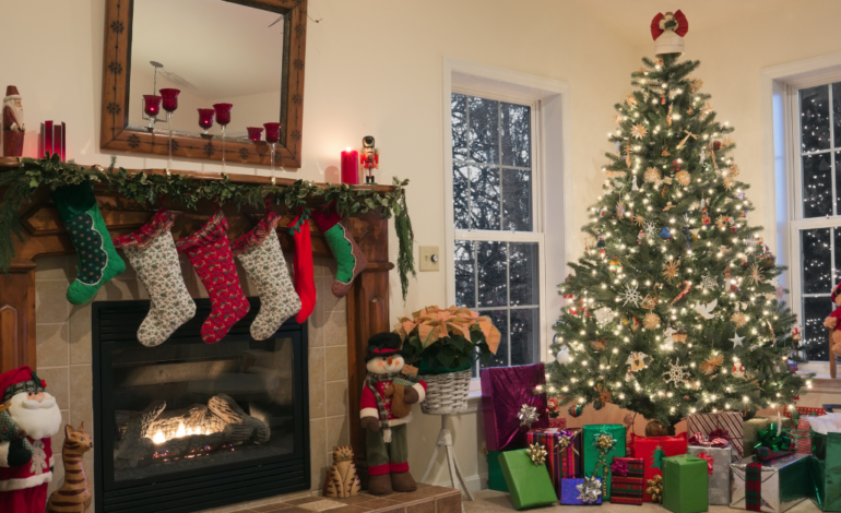 christmas tree with presents underneath and stocking hung above fireplace