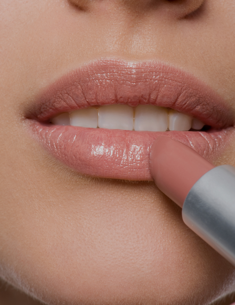 female lips putting on satin lipstick