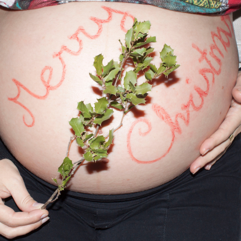 merry christmas painted on pregnant belly