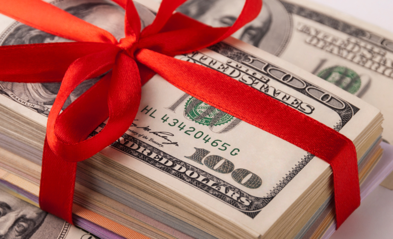 Money stack wrapped in red bow