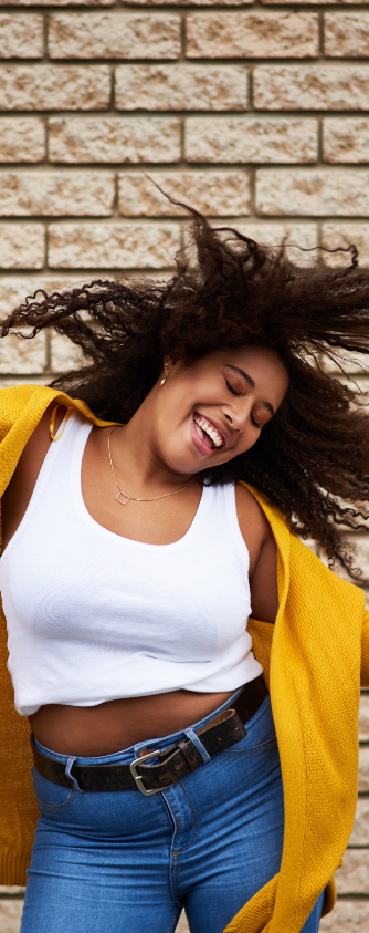 Plus sized black woman in yellow smiling