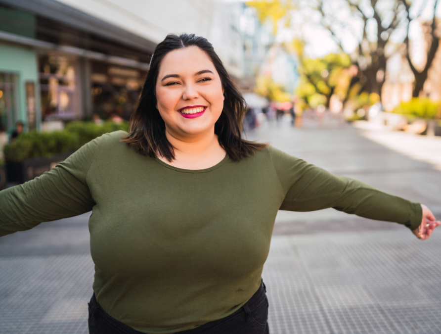 Plus sized woman in green smiling