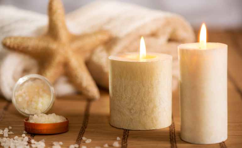 candles lit and bath salts spread with starfish coastal scene in background