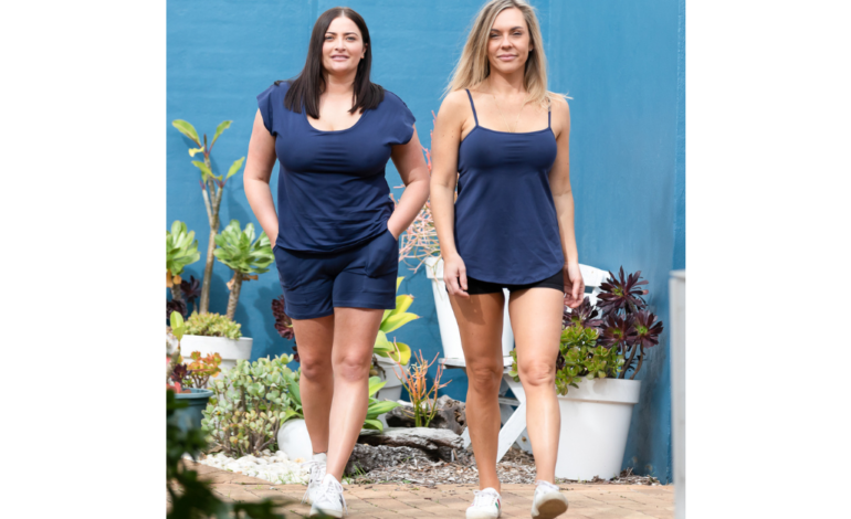 2 women walking in blue outfits