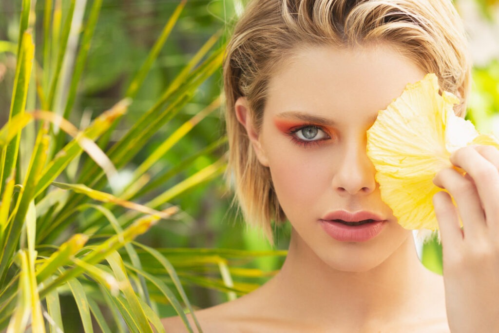 Woman with Yellow flower over face and eye