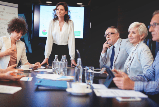 Woman at head of board meeting table
