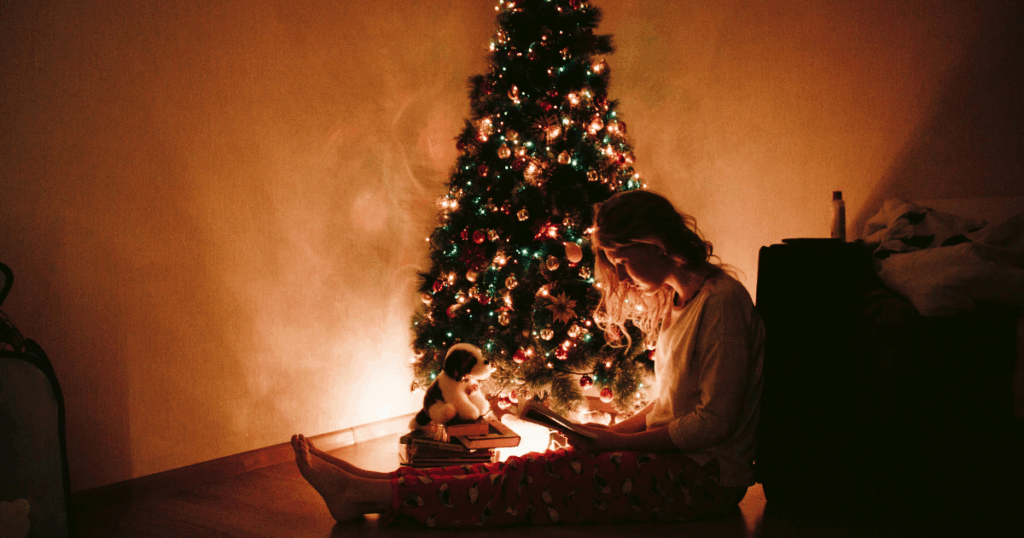 Woman with child by Christmas Tree