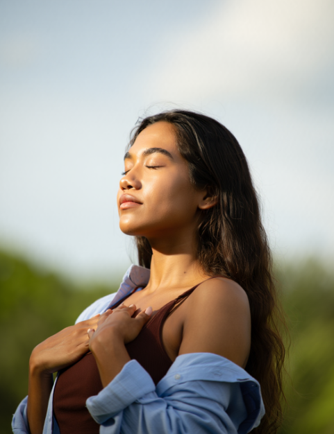 woman with hands on chest meditating